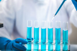 Researchers,Scientist,Working,Analysis,With,Blue,Liquid,Test,Tube,In