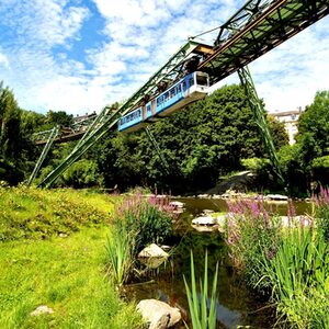 Die Schwebebahn fährt über der Wupper entlang.